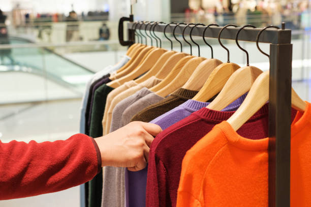 istock A man chooses clothes in a retail mall, close up. 1360457190