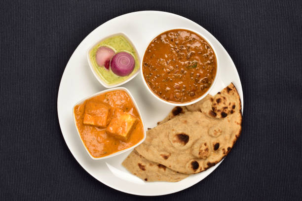 Plate of Indian Main Course, Dal Makhani and Paneer Butter Masala Served with  Tandoori Roti and Chutney stock photo