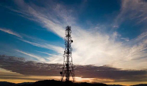 Photo of Silhouettes sunrise 5G Cell Tower Cellular communications tower for mobile phone and video data transmission