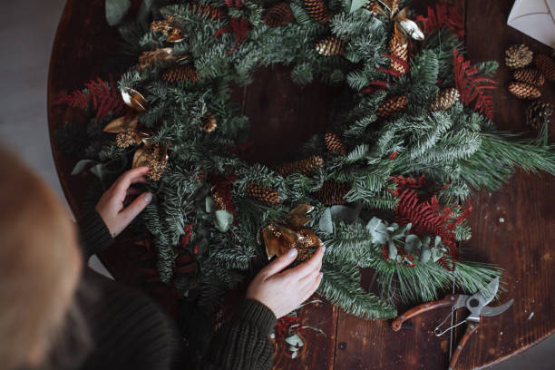 istock Girl making a handmade christmas wreath 1360460972