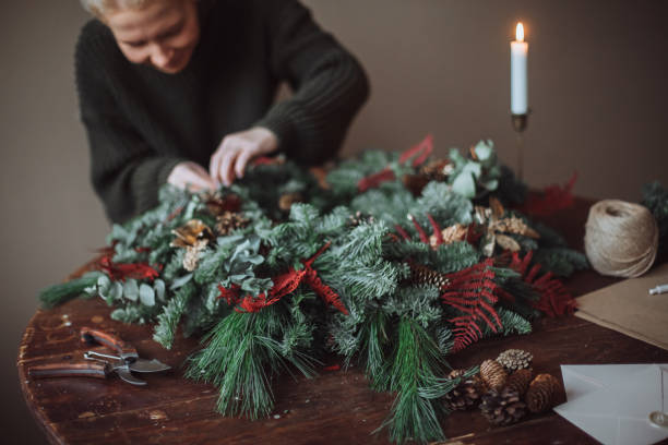 istock Girl making a handmade christmas wreath 1360461007