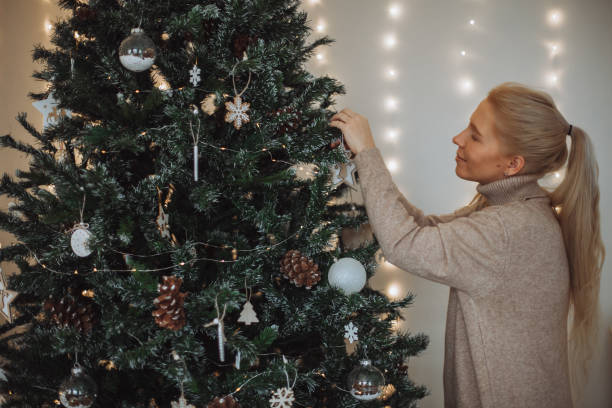 istock Girl decorate the christmas tree 1360461101