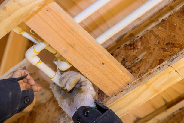 istock A plumber in a plastic water pipe into putting glue on a PVC pipe 1360461111