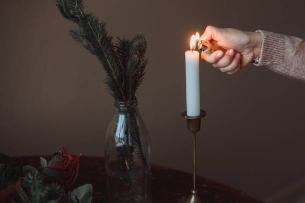 istock Girl lights a candle 1360461113