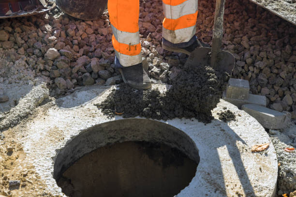 istock A worker the new road construction work on preparation for installation of sewer hatches 1360461189