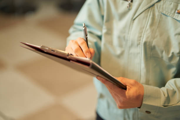 Asian man inspecting restaurant equipment Asian man inspecting restaurant equipment official visit stock pictures, royalty-free photos & images