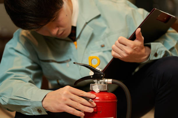 Asian man inspecting restaurant equipment