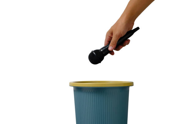 istock Sound microphone for vocal singing is thrown into trash, on white background isolate. 1360467213