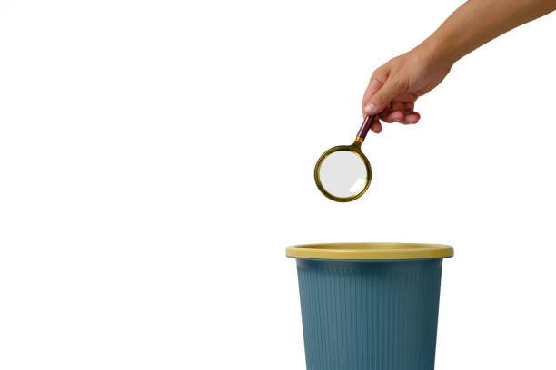 istock Magnifying glass is thrown into trash.Concept of meaningless search. 1360467251