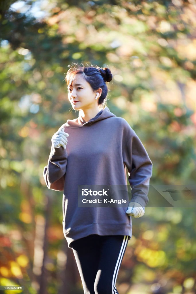 A young Asian woman exercising in the park in the park Racewalking Stock Photo