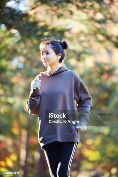 A Young Asian Woman Exercising In The Park Stock Photo - Download Image Now - Racewalking, Walking, Relaxation Exercise