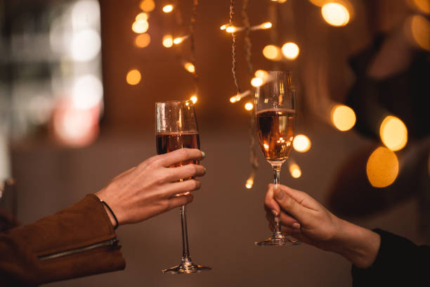 celebratory toast with string lights cheers - political party concepts glamour friendship imagens e fotografias de stock