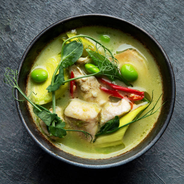 istock Green curry with chicken in bowl on dark background. 1360470127