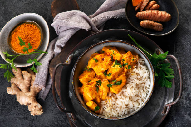istock Indian butter chicken curry with basmati rice on dark background. 1360470152