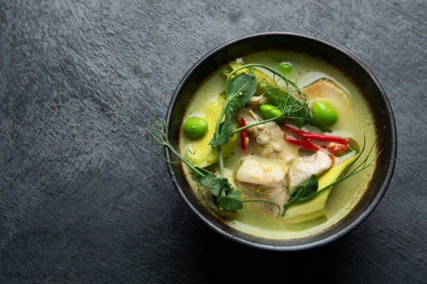 istock Green curry with chicken in bowl on dark background. 1360470280