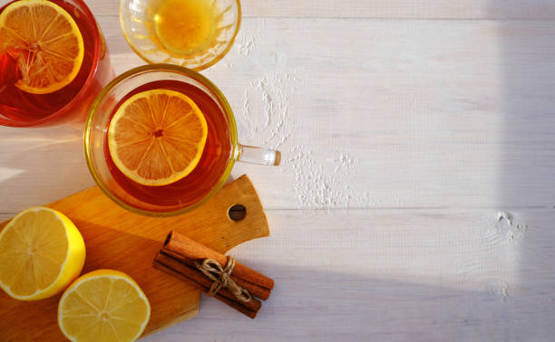 istock Tea with lemon, cinnamon and honey, on a light wooden background. Layout with space for text 1360472060