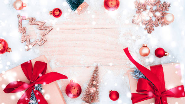 istock Xmas background table. Winter wooden decoration backdrop. Christmas board with old rustic wall, white frozen snow, golden balls and gift box. Minimal flat lay. 1360472649