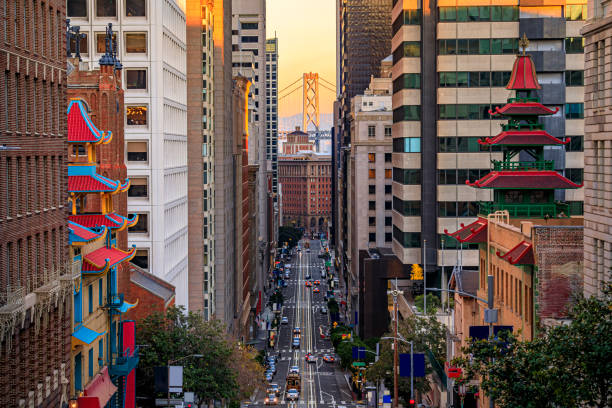 California Street near China Town with the Bay Bridge at sunset, San Francisco Famous view of California Street near China Town and the Financial District, with Chinese pagoda towers and the Bay Bridge at sunset in San Francisco san francisco california stock pictures, royalty-free photos & images