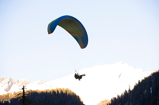 Paragliding over Alpine Landscape in Muottas Muragl, Engadine Valley, Graubunden, Swiss Alps above St Moritz, Switzerland
