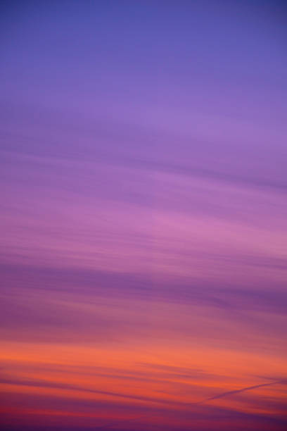 Vivid evening sky colors in winter. Orange, purple and blue sunset. Bright twilight in winter. Romantic view. Selective focus on the details, blurred background.
