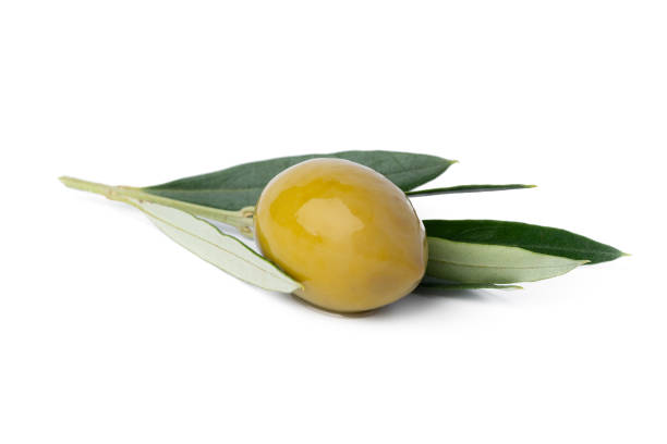 istock Green olives with leaves isolated on white background. 1360475395