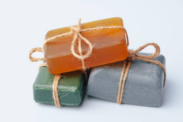istock Natural soap bars tied with ribbon isolated on white 1360476349