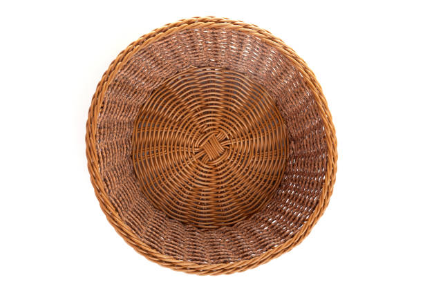 istock empty round wicker basket for fruit or sweets on a white background, top view 1360479129