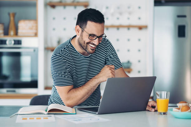 istock Young man using laptop at home for an online meeting 1360480038