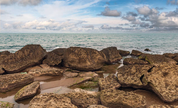 istock Sea coast with big boulders 1360480143