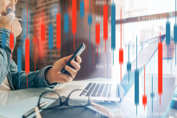 istock Businessman working remotely from home. Technical price graph and indicator, candlestick chart and stock trading computer screen background. Double exposure. Trader analyzing data at remote work 1360481624