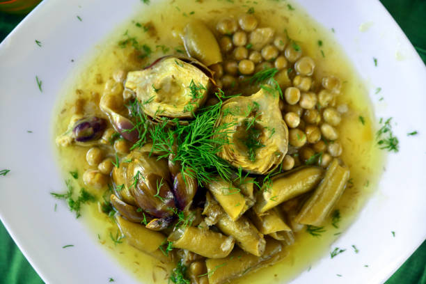 Vegan food; Artichoke with broad bean and peas stock photo