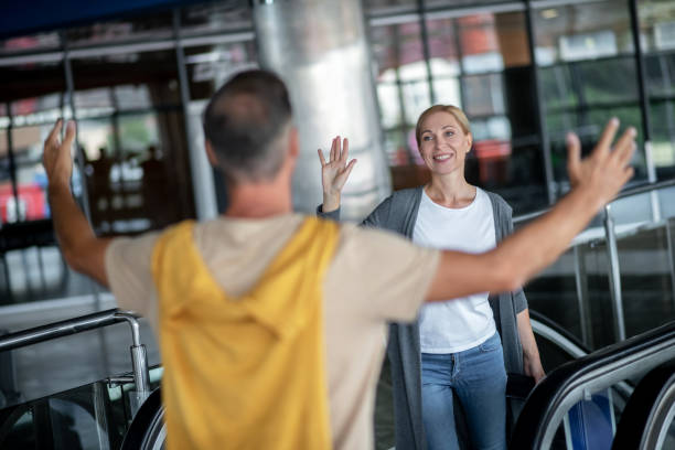 istock Short-haired guy welcoming a joyous airline passenger 1360486612