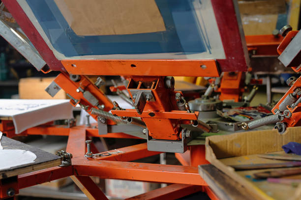 istock silk screen textile printery. print screening apparatus. serigraph printing production 1360486613