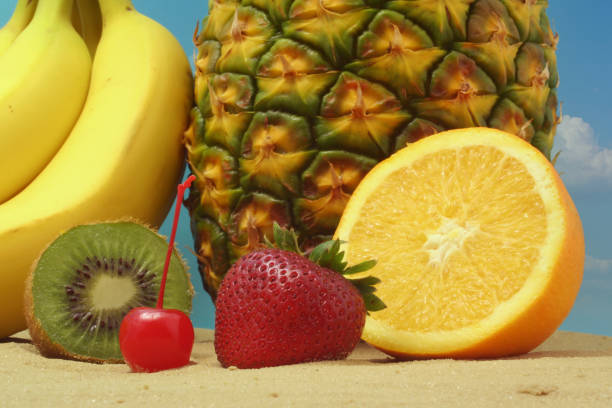 istock Fruit on Beach Orange and Pineapple With Strawberry 1360488602