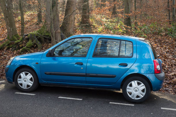 Profile view of blue Renault clio 2 parked on the road stock photo