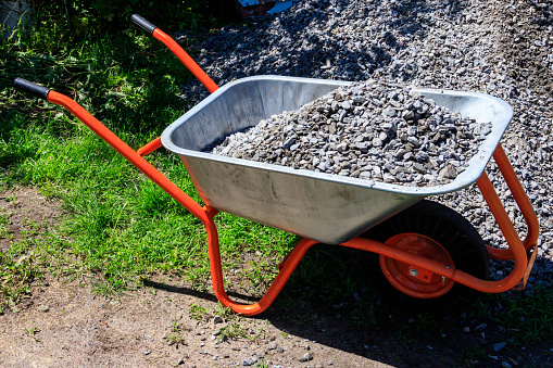 Wheelbarrow with gravel at the construction site