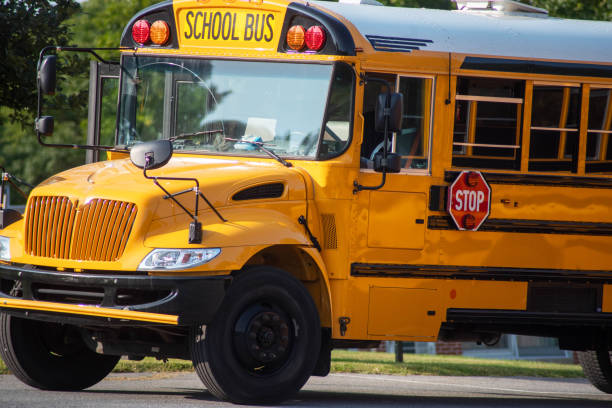 istock Closeup of front end of a schoolbus on a sunny day 1360491768