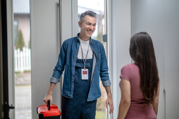 istock Joyful man with suitcase of tools and woman 1360492022