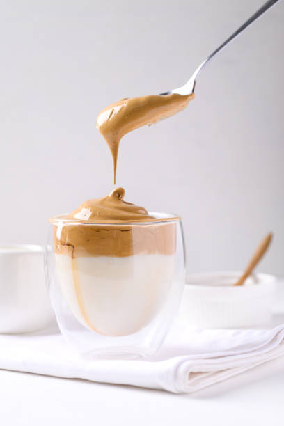 istock Dalgona coffee, Fluffy cream coffee whipping on cold or hot milk 1360493235