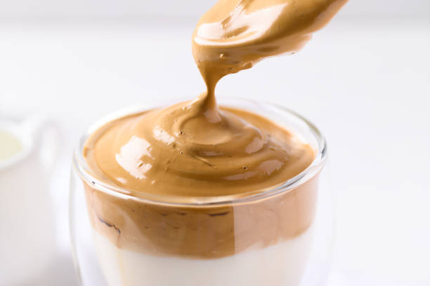 istock Dalgona coffee, Fluffy cream coffee whipping on cold or hot milk 1360493238