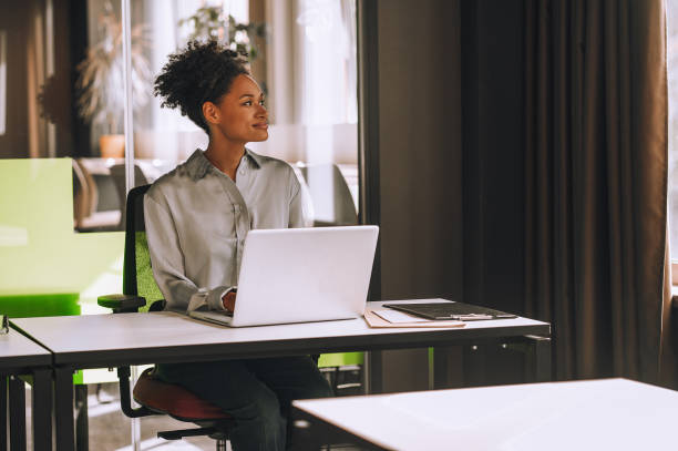 istock Young black woman at her working place in the office 1360494555