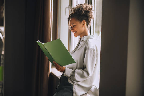 istock Young businesswoman with project documentation in the office 1360494588