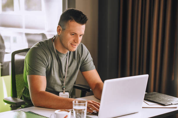 istock Handsome young man working at the laptop 1360494613