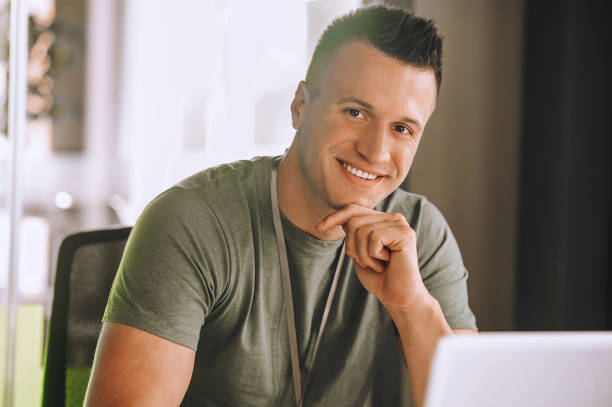 istock Handsome young man working at the laptop 1360494617