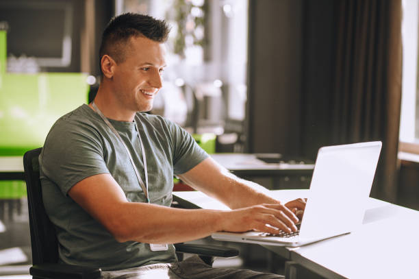 istock Handsome young man working at the laptop 1360494622