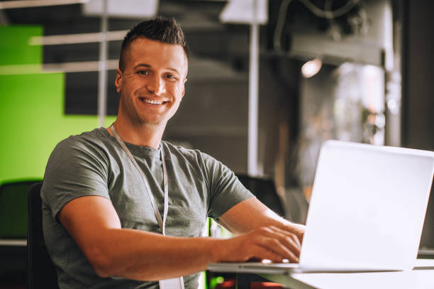 istock Short-haired young guy sitting at the laptop 1360494623