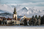 Tower of church in village Liskova, Slovakia. Peak Krivan at background