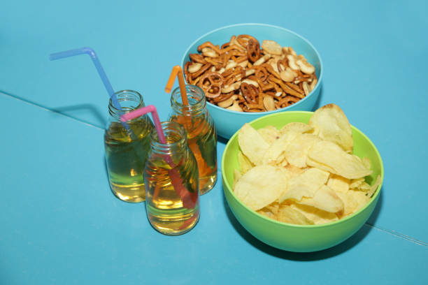 st patricks day with Chips, salty snacks, and Beer on a table. Saint celebration with lucky shamrock bonbon