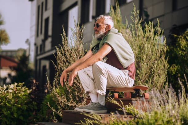 istock Serene skateboarder sitting on the skateboard placed on the staircase 1360498823