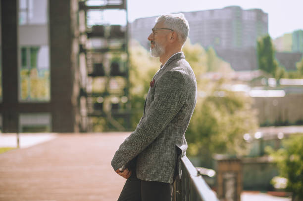 istock Stylish man in eyeglasses staring into the distance 1360498853